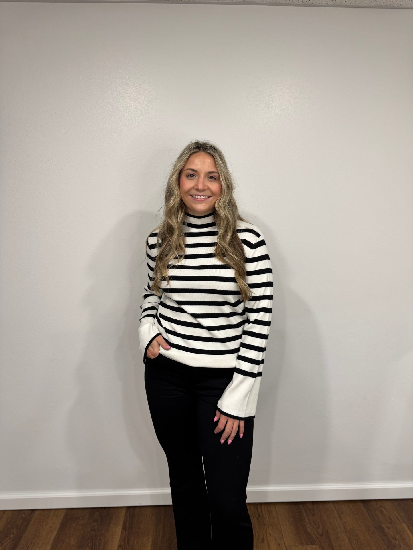 Person wearing a black and white striped sweater 
