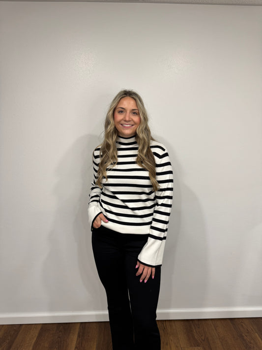 Person wearing a black and white striped sweater